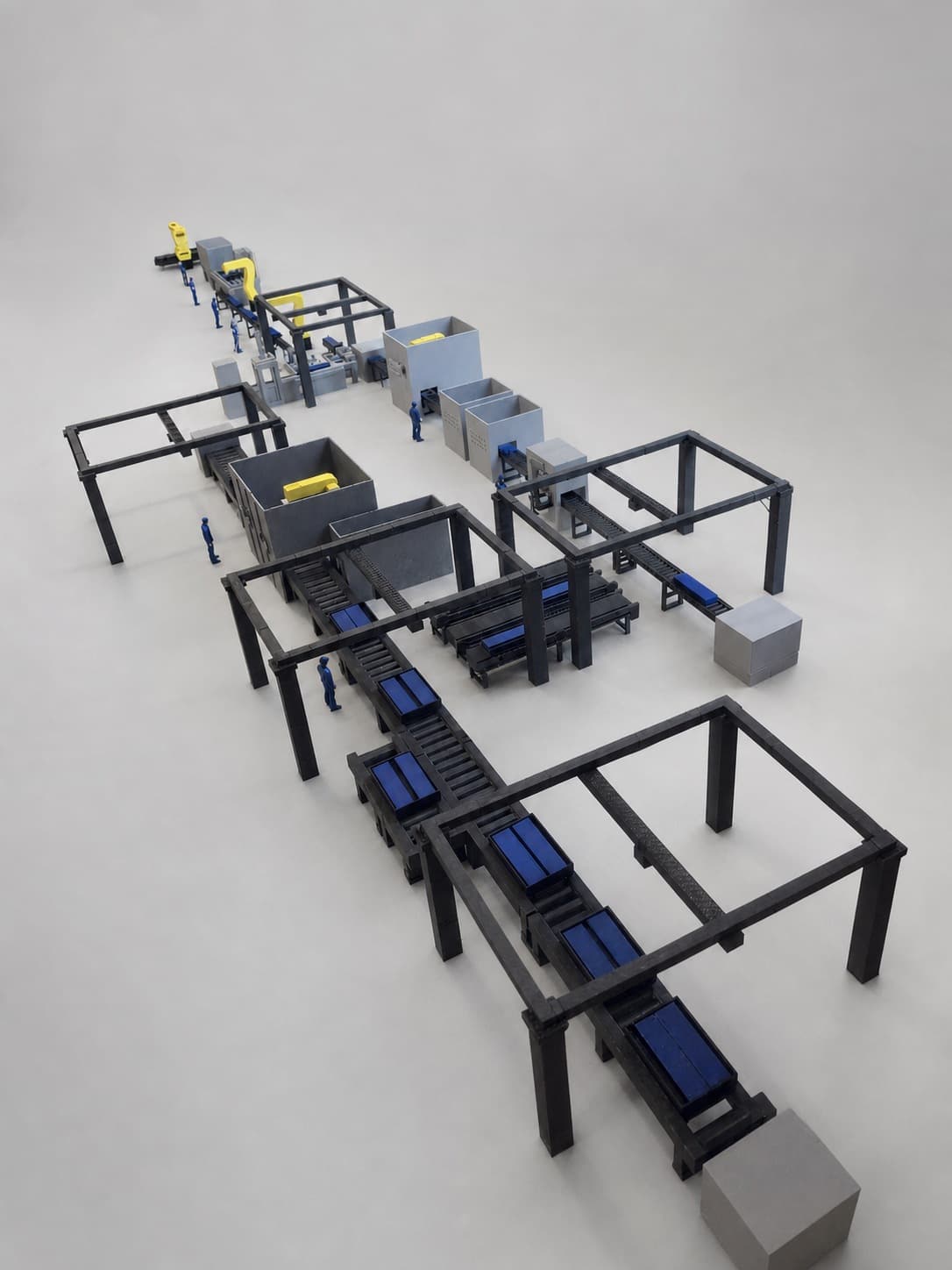Lengthwise view through the factory scale model showing linked conveyors, framed work cells and operator figures.